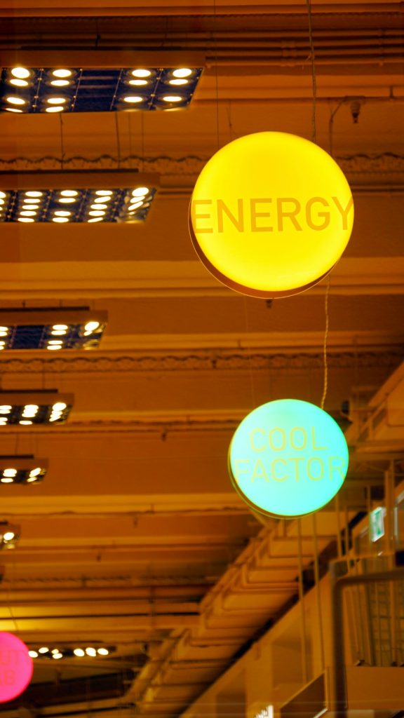 a-group-of-neon-signs-hanging-from-the-ceiling-of-a-building-emmyogmajwa