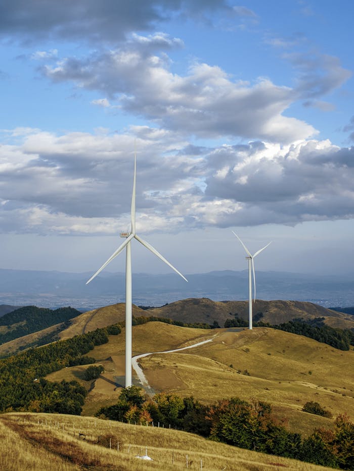 Majestic wind turbines standing tall in a picturesque mountain terrain, promoting renewable energy and sustainability.